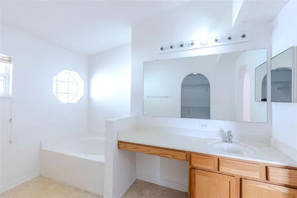 a spacious bathroom with a granite countertop sink a toilet and shower