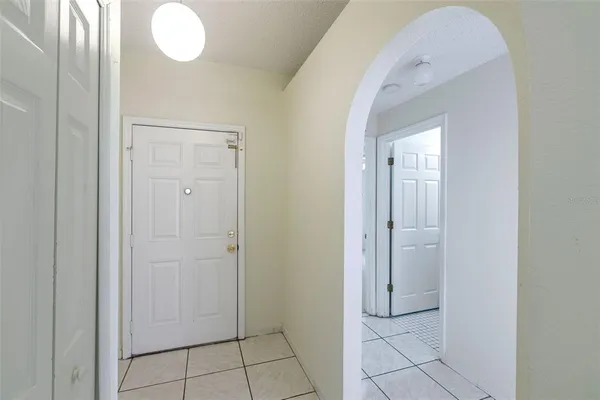 an empty room with a ceiling fan and bathroom view