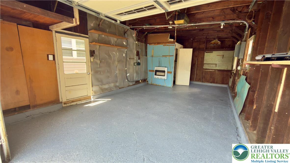 246 Poplar Street Bath, PA 18014 - Photo 8 of 34 A utilitarian garage space offers ample storage with durable concrete flooring.