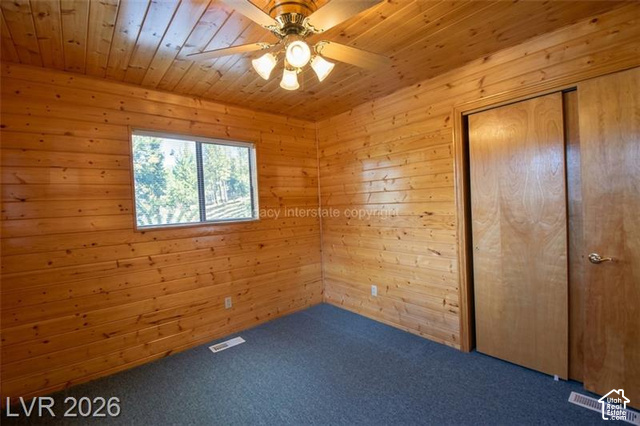 1129 Ponderosa Road, Unit 40 Hatch, UT 84735 - Photo 31 of 47 Wood-paneled walls and ceiling, wall-to-wall carpeting, window with outdoor scenery, and a ceiling fan with integrated lighting
