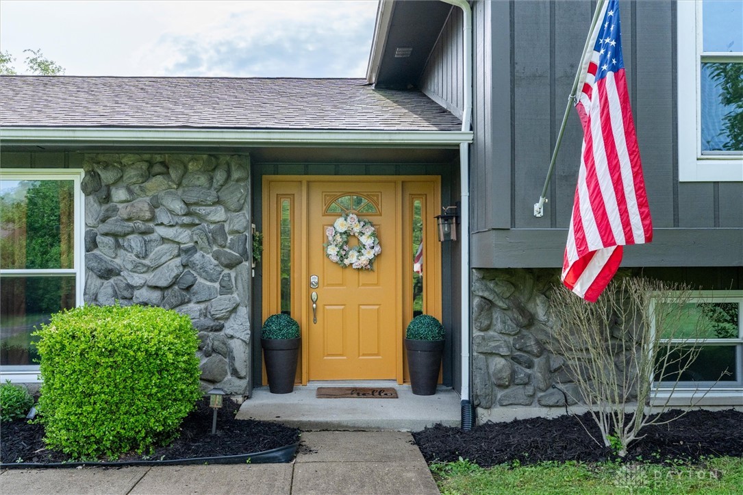 2165 Stewart Road Xenia, OH 45385 - Photo 58 of 59 This inviting entrance features a warm wooden door flanked by natural stone accents.