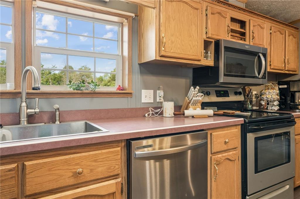 275 Adamik Road Clarksville, PA 15322 - Photo 15 of 39 a kitchen with stainless steel appliances a sink a stove and a microwave