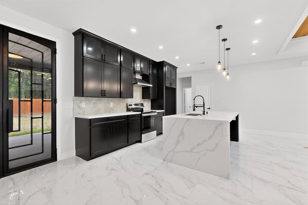 404 Luzon Street Tool, TX 75143 - Photo 12 of 40 a large white kitchen with stainless steel appliances