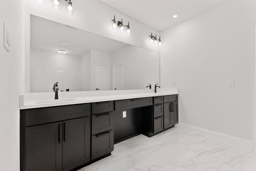404 Luzon Street Tool, TX 75143 - Photo 19 of 40 a spacious bathroom with a double vanity sink double and mirror
