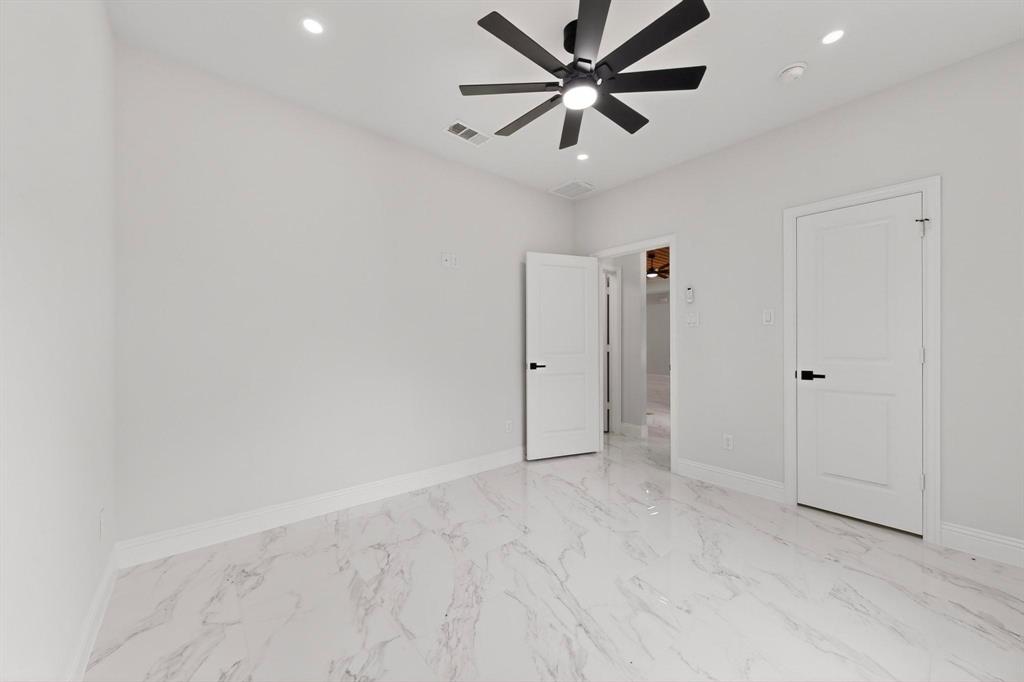 404 Luzon Street Tool, TX 75143 - Photo 25 of 40 an empty room with closet and a ceiling fan