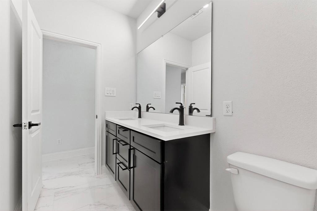404 Luzon Street Tool, TX 75143 - Photo 30 of 40 a bathroom with a sink a toilet and shower