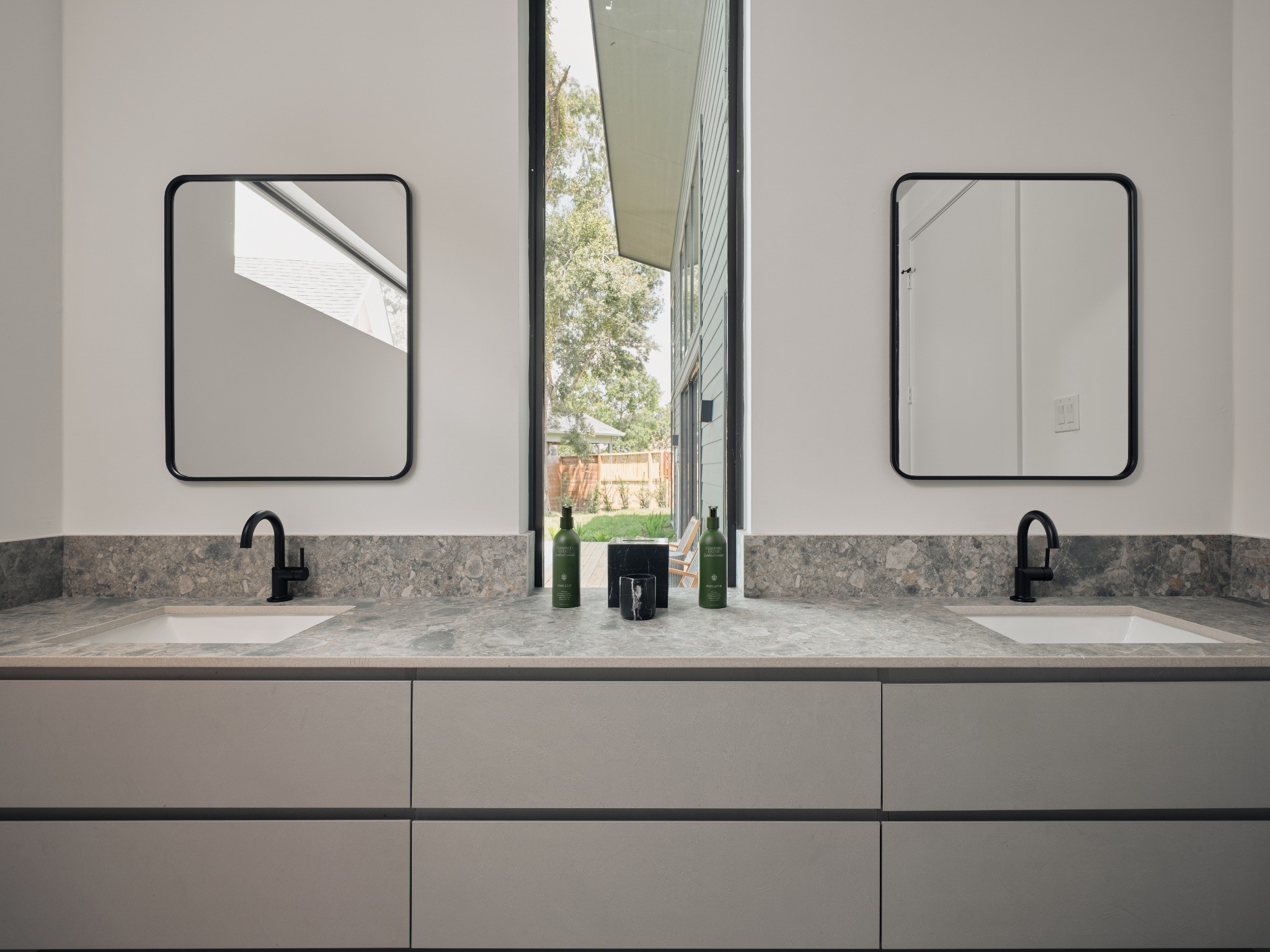 10941 Bluebird Place Conroe, TX 77385 - Photo 16 of 33 Double vanity with window in the primary bathroom