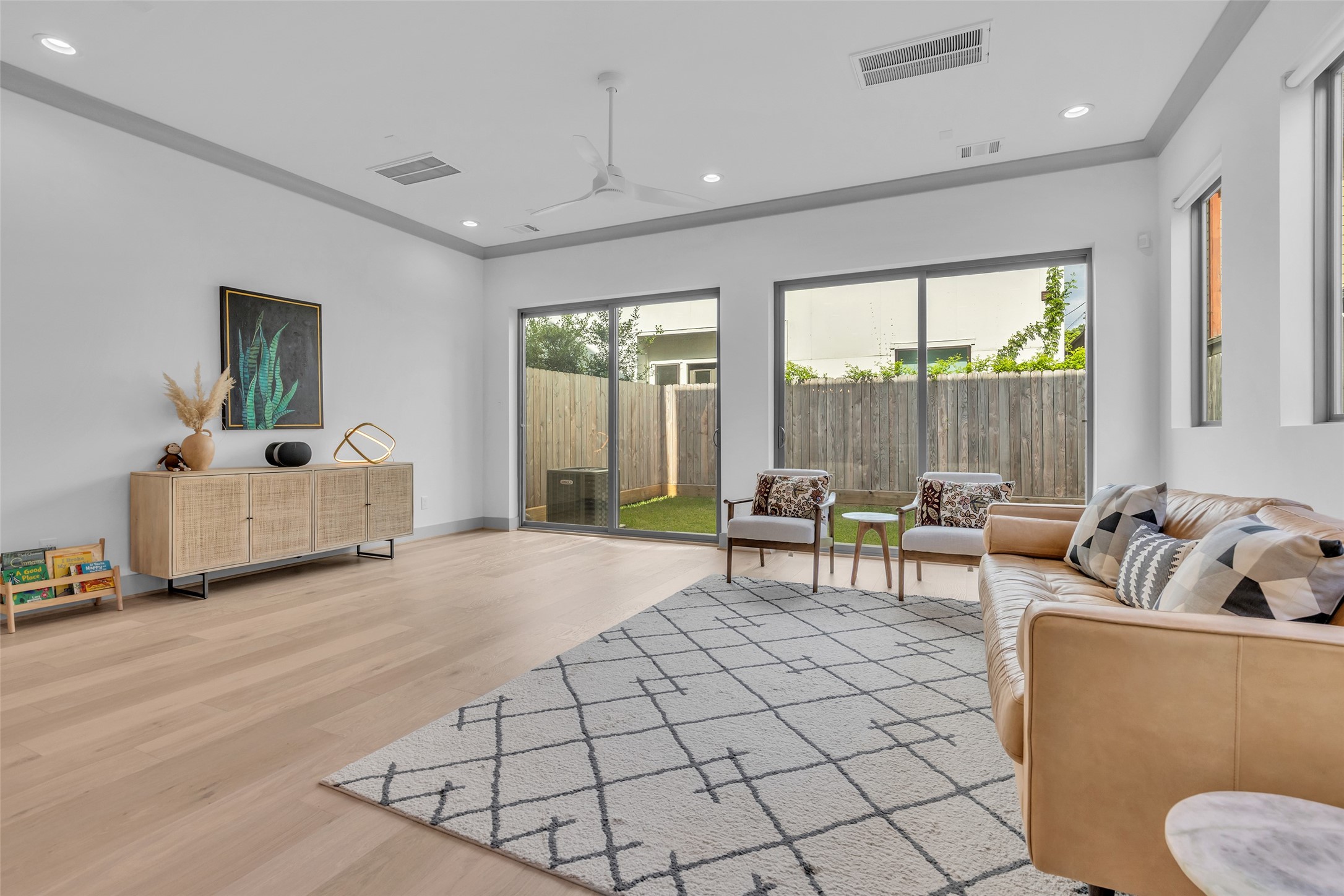 1724 Ridgewood Street Houston, TX 77006 - Photo 14 of 38 Another view of the living room highlights the natural light coming through the glass doors, which provide a connection to the outdoor space and brighten the room.