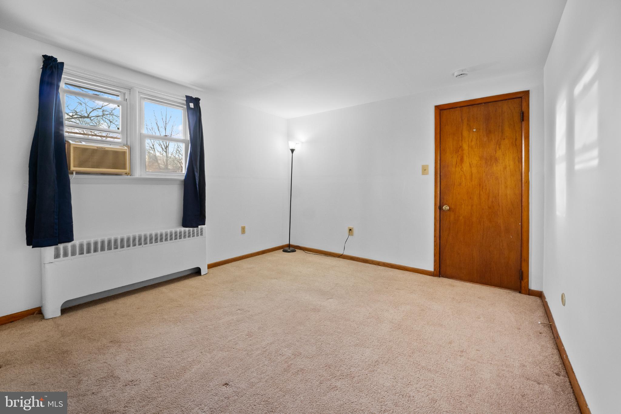 842 Bethlehem Pike, Unit B Colmar, PA 18915 - Photo 11 of 13 a view of an empty room with wooden floor and a window