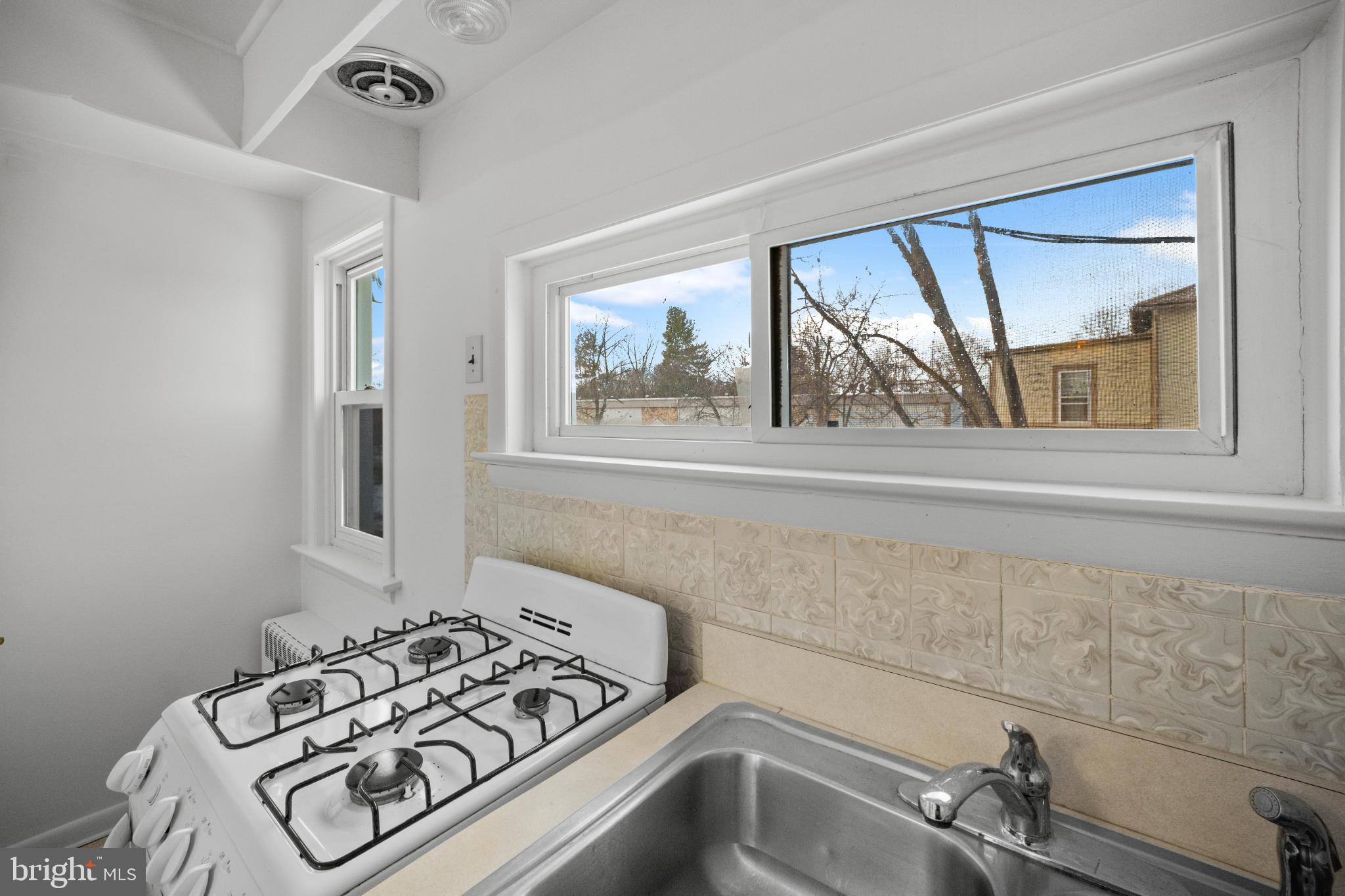 842 Bethlehem Pike, Unit B Colmar, PA 18915 - Photo 6 of 13 a view of a sink and a stove in a room