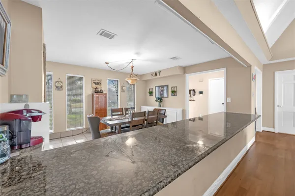 a view of a dining room with furniture and window
