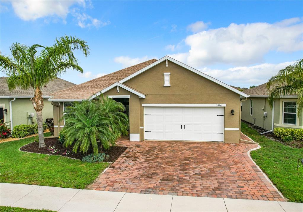 a front view of a house with a yard and garage