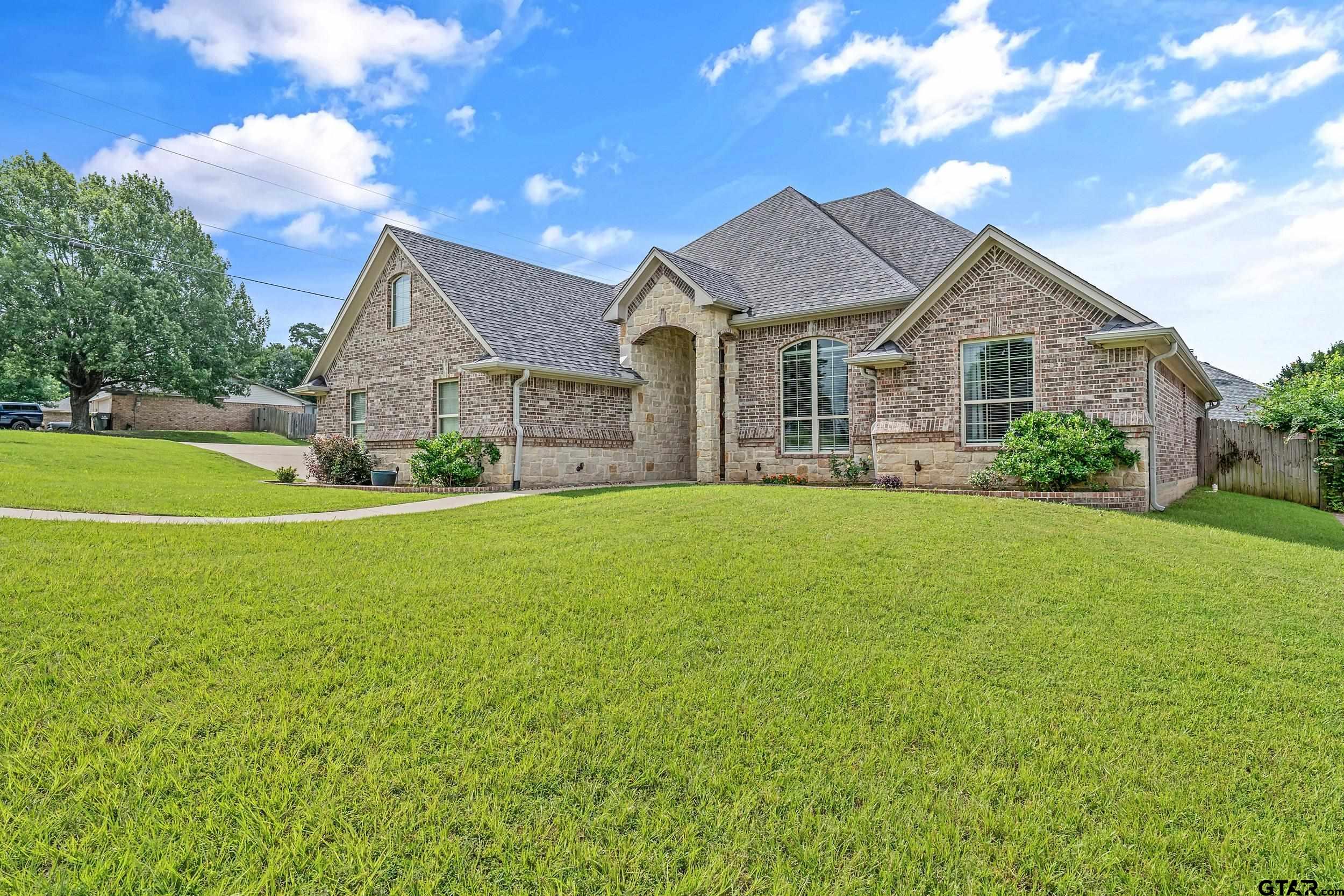 11775 Belle Chase Tyler, TX 75703 - Photo 1 of 28 a view of a house next to a big yard and large trees