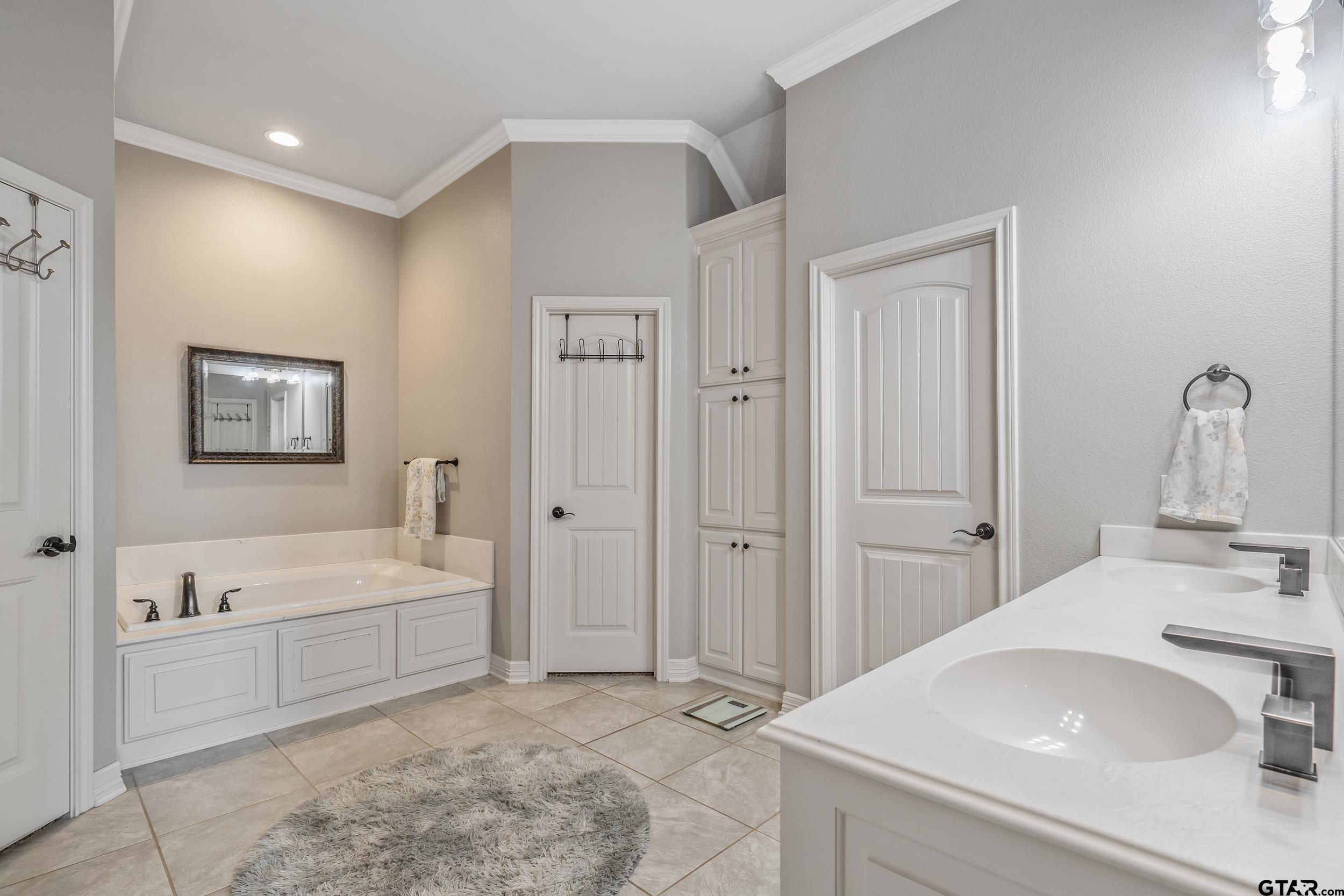 11775 Belle Chase Tyler, TX 75703 - Photo 15 of 28 a spacious bathroom with a tub sink and mirror