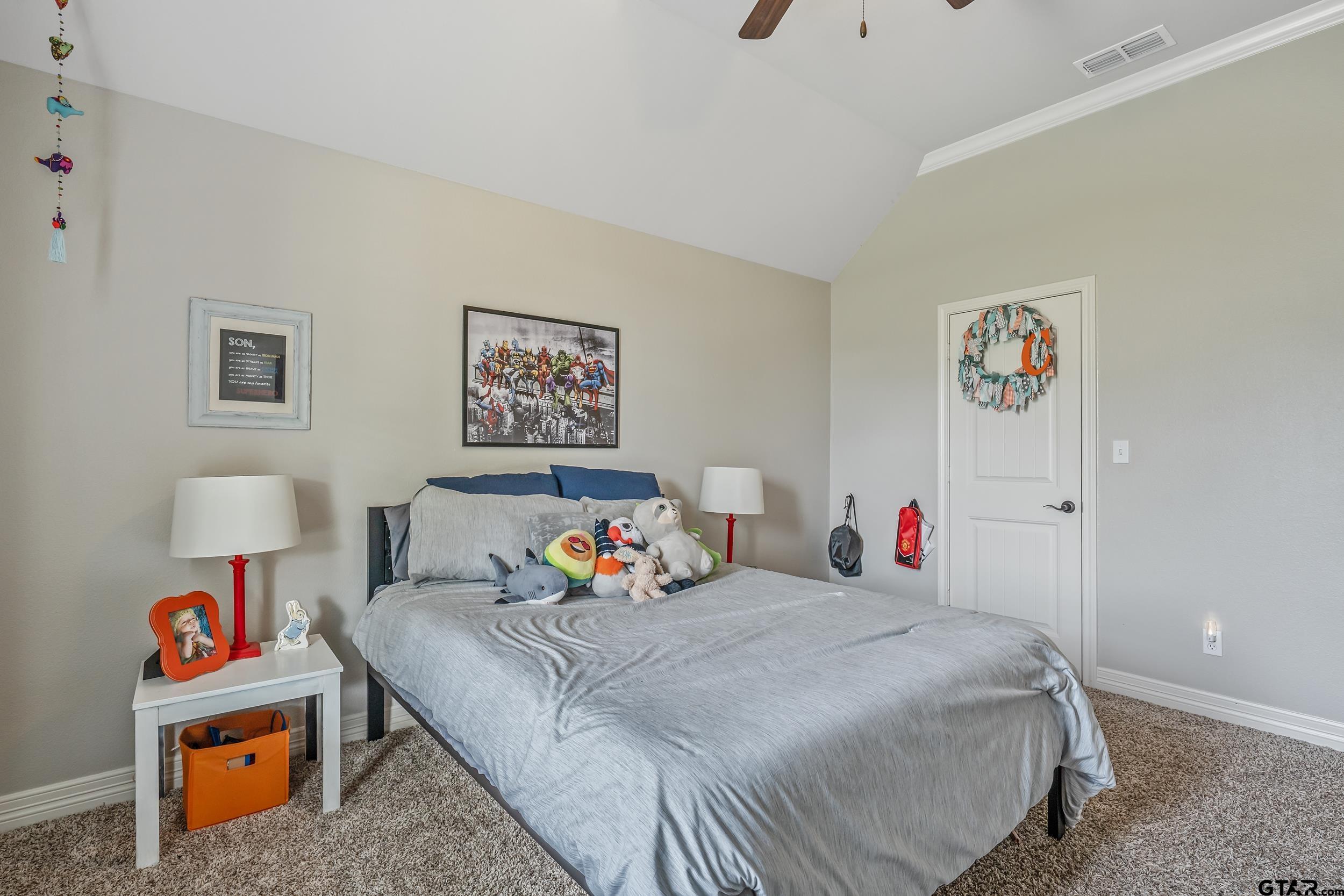 11775 Belle Chase Tyler, TX 75703 - Photo 17 of 28 a bedroom with bed and a book shelf