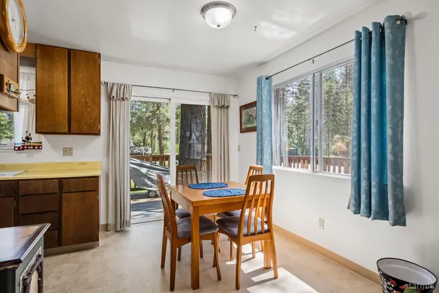 a view of a dining room with furniture and window