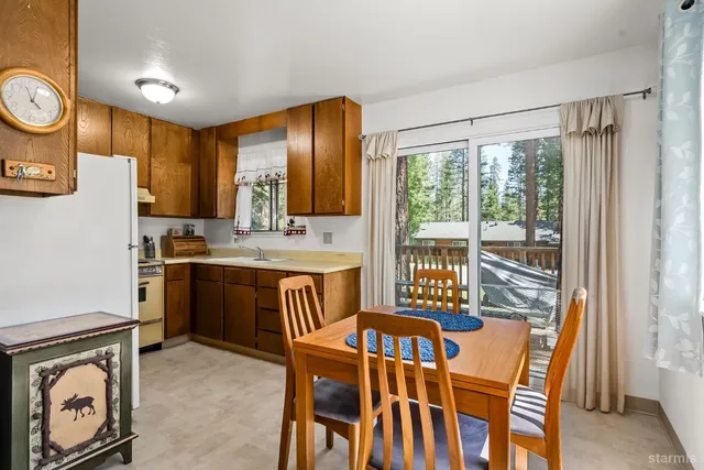 a dining room with furniture a flat screen tv and a window