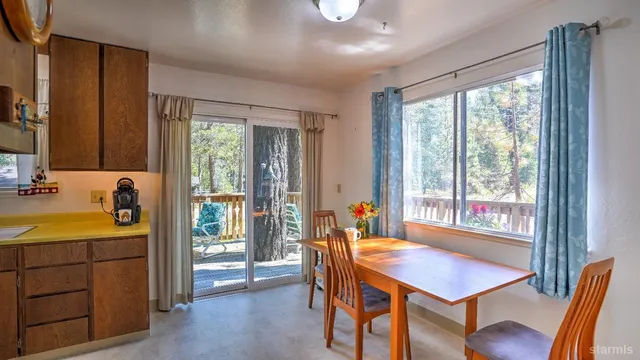 a view of a dining room with furniture and window