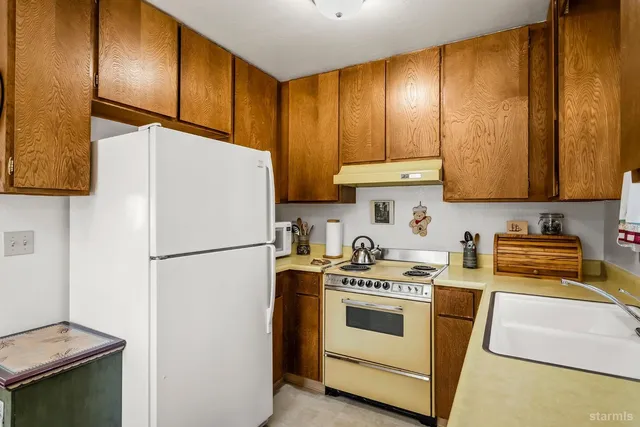 a white refrigerator freezer sitting inside of a kitchen