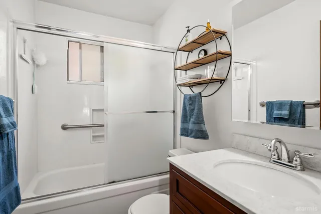 a bathroom with a sink a mirror and a shower