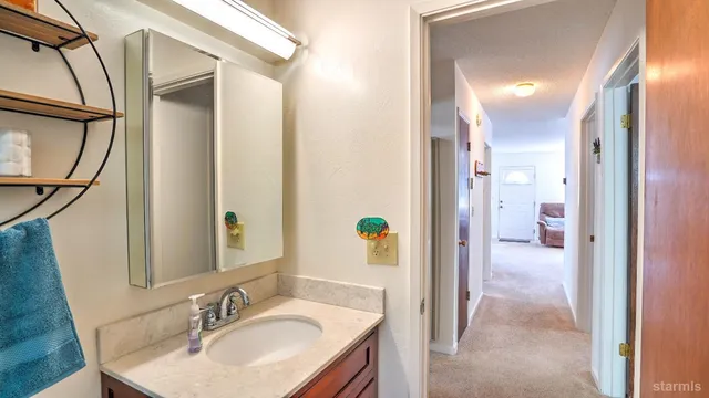 a en suite bathroom with a sink and a mirror