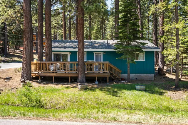 a front view of a house with a yard table and chairs