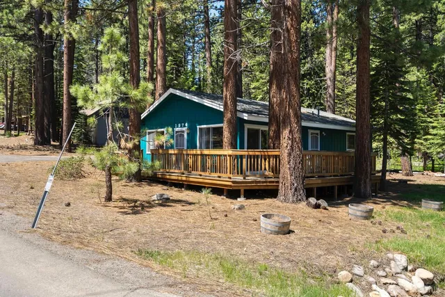 a backyard of a house with barbeque oven and trees