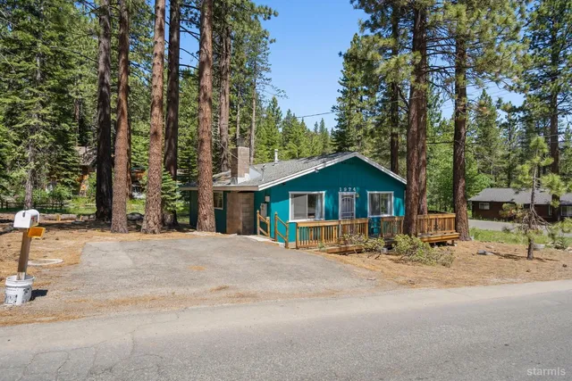a wooden bench sitting in front of a building