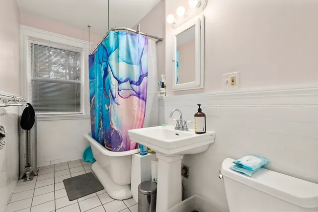 a bedroom with bed and a large window