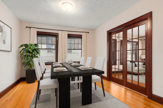 a living room with furniture and floor to ceiling windows
