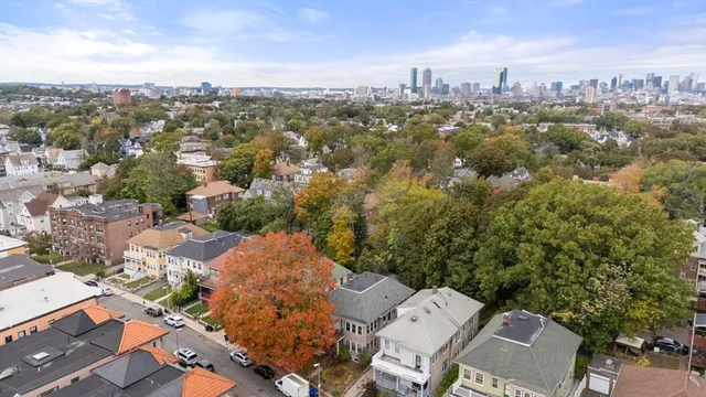 an aerial view of a house with a yard