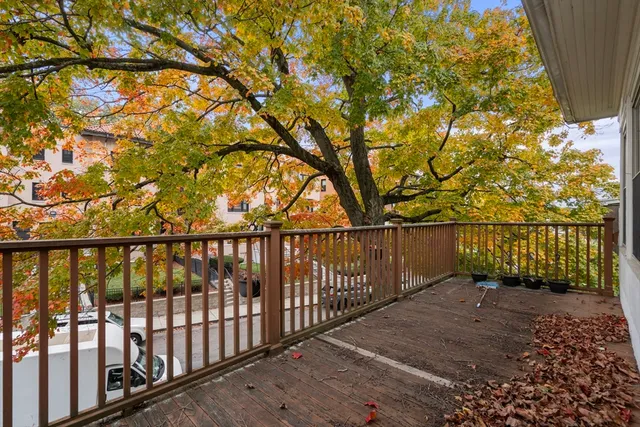 a balcony with trees in front of it
