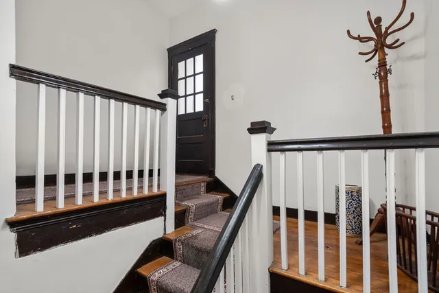 a living room with furniture a flat screen tv and a floor to ceiling window