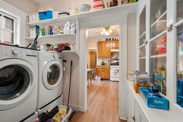 a kitchen with stainless steel appliances a stove a sink dishwasher and a refrigerator with wooden floor