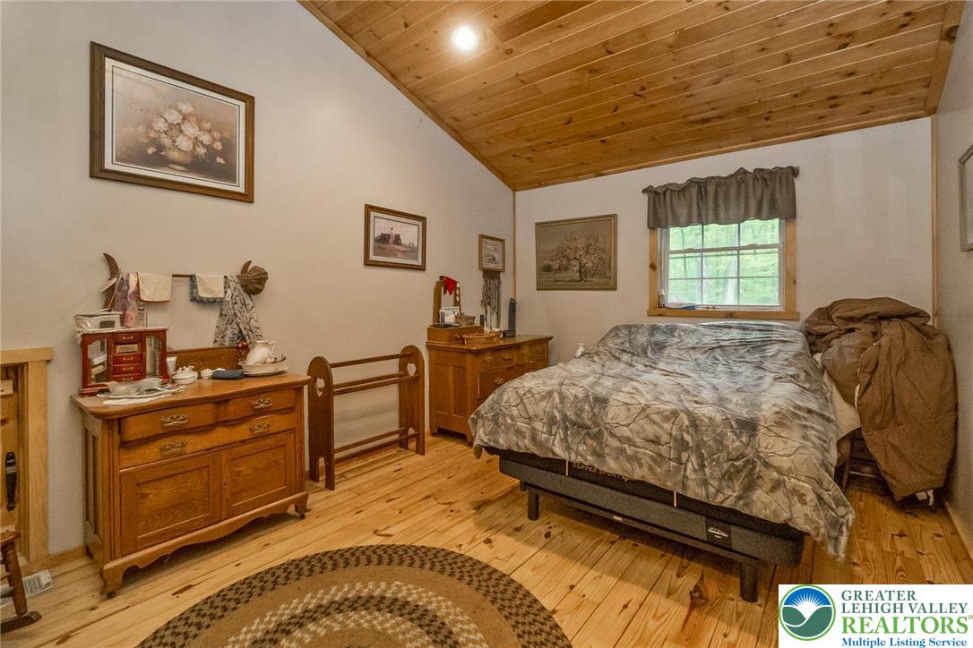 9223 North Loop Road Slatington, PA 18080 - Photo 26 of 60 a bedroom with a bed and wooden floor