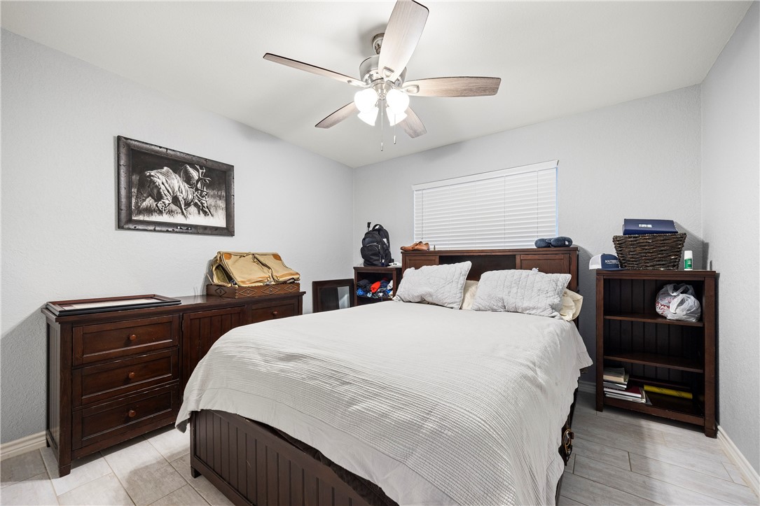 15730 Escapade Street Corpus Christi, TX 78418 - Photo 14 of 22 a bedroom with bed and wooden floor