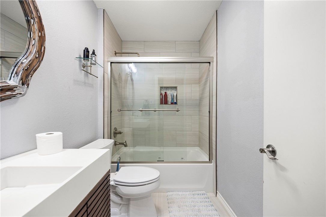 15730 Escapade Street Corpus Christi, TX 78418 - Photo 18 of 22 a bathroom with a sink a toilet and shower