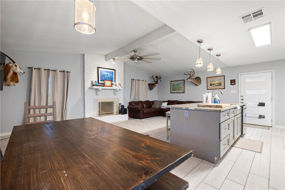 15730 Escapade Street Corpus Christi, TX 78418 - Photo 6 of 22 a living room with stainless steel appliances kitchen island granite countertop furniture and a kitchen view