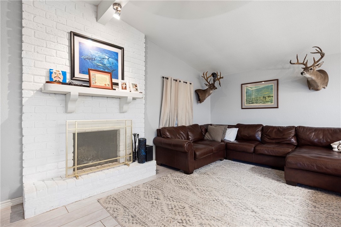 15730 Escapade Street Corpus Christi, TX 78418 - Photo 8 of 22 a living room with furniture and a fireplace