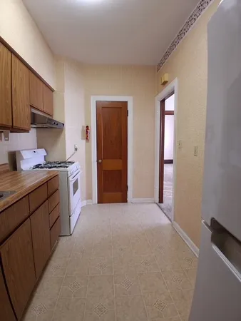 a kitchen with stainless steel appliances granite countertop a refrigerator and a stove top oven