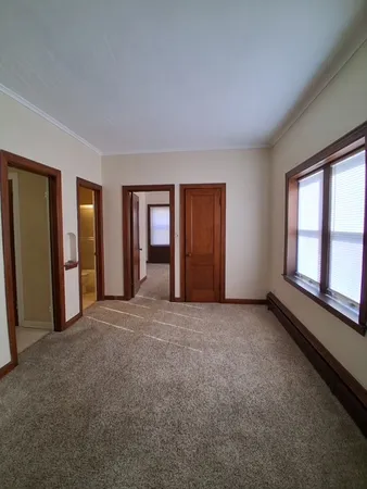 an empty room with windows and closet