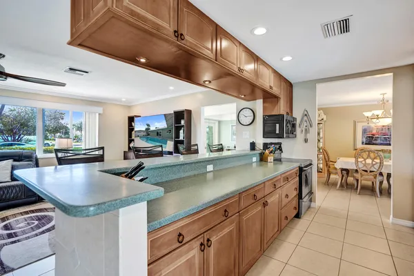 a kitchen with stainless steel appliances a refrigerator and a stove top oven