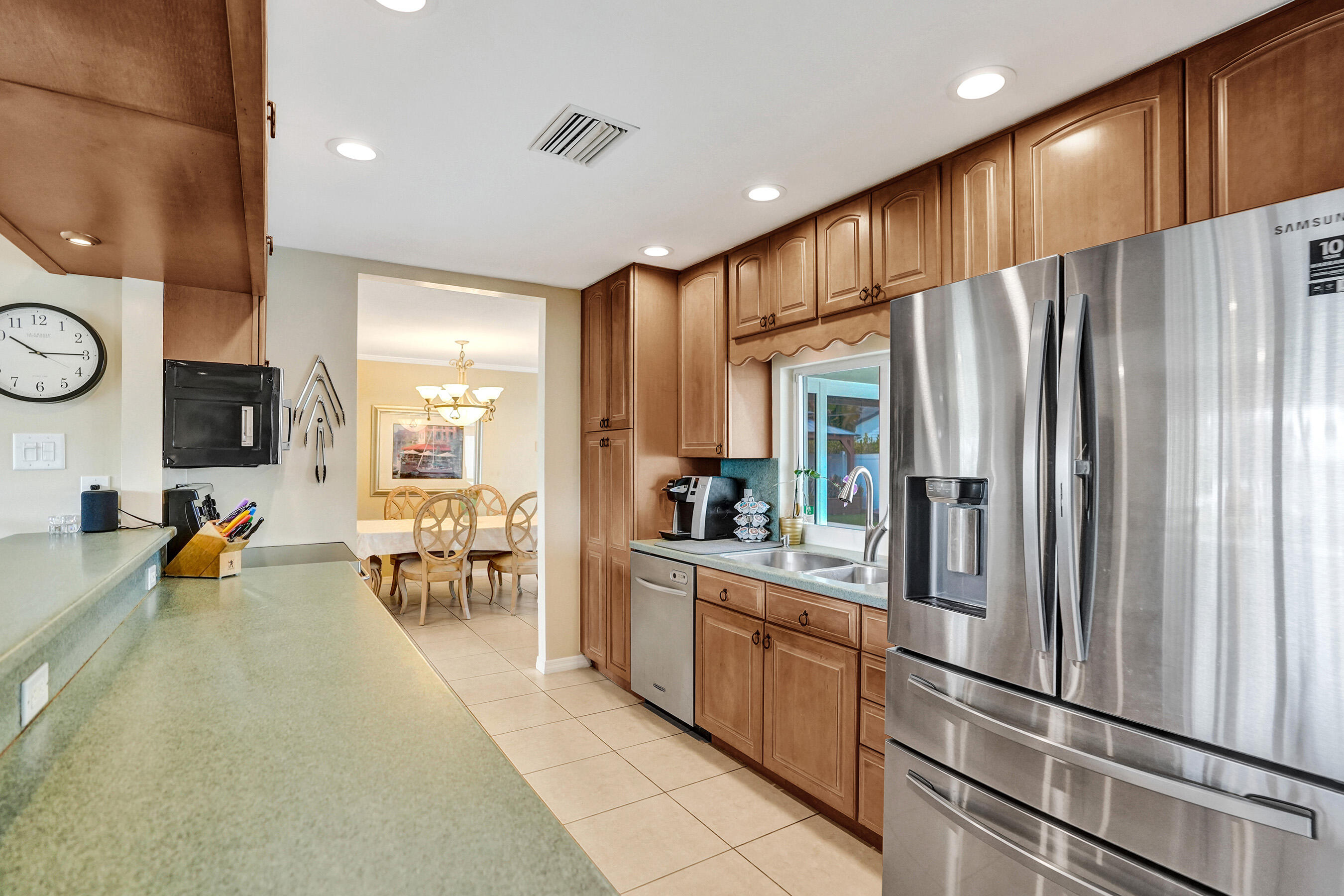 3001 Northeast 45th Street Lighthouse Point, FL 33064 - Photo 12 of 67 a kitchen with stainless steel appliances a refrigerator and a stove top oven
