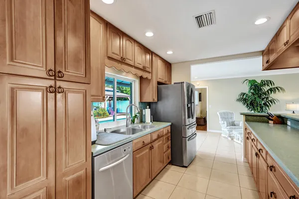 a kitchen with stainless steel appliances granite countertop a sink counter space cabinets and a stove
