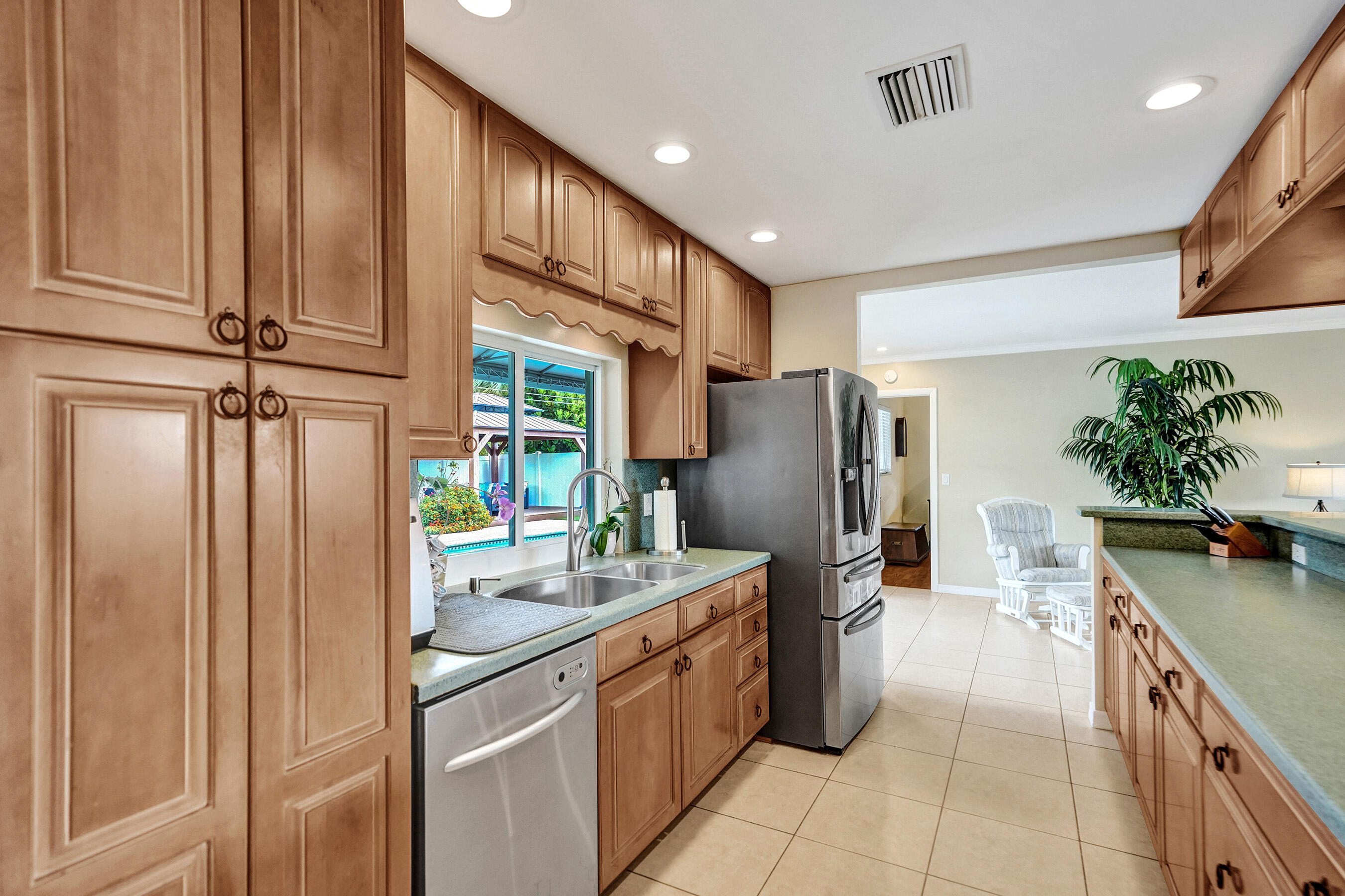 3001 Northeast 45th Street Lighthouse Point, FL 33064 - Photo 14 of 67 a kitchen with a refrigerator and a sink
