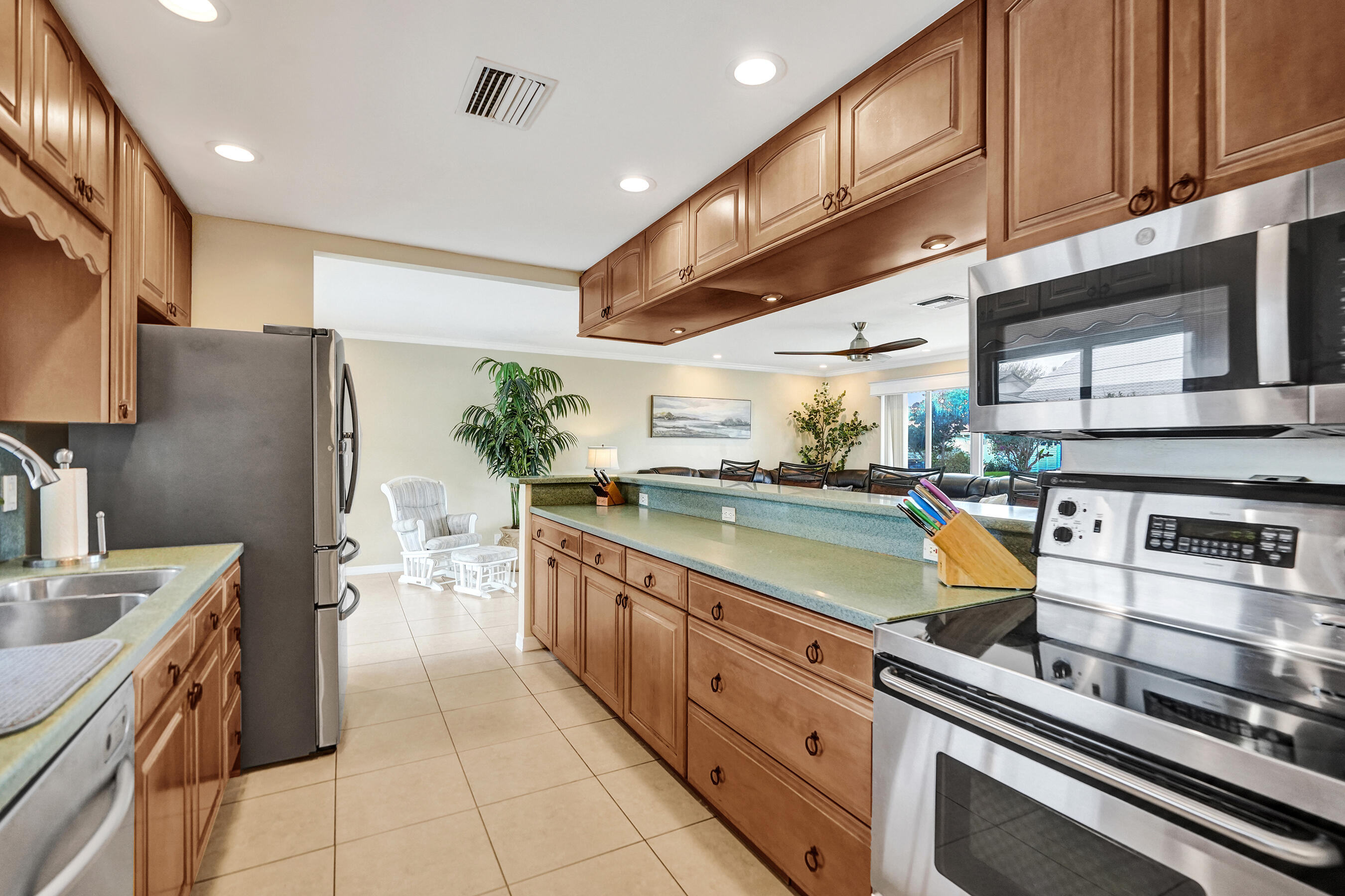 3001 Northeast 45th Street Lighthouse Point, FL 33064 - Photo 15 of 67 a kitchen with stainless steel appliances granite countertop a sink a stove and a refrigerator