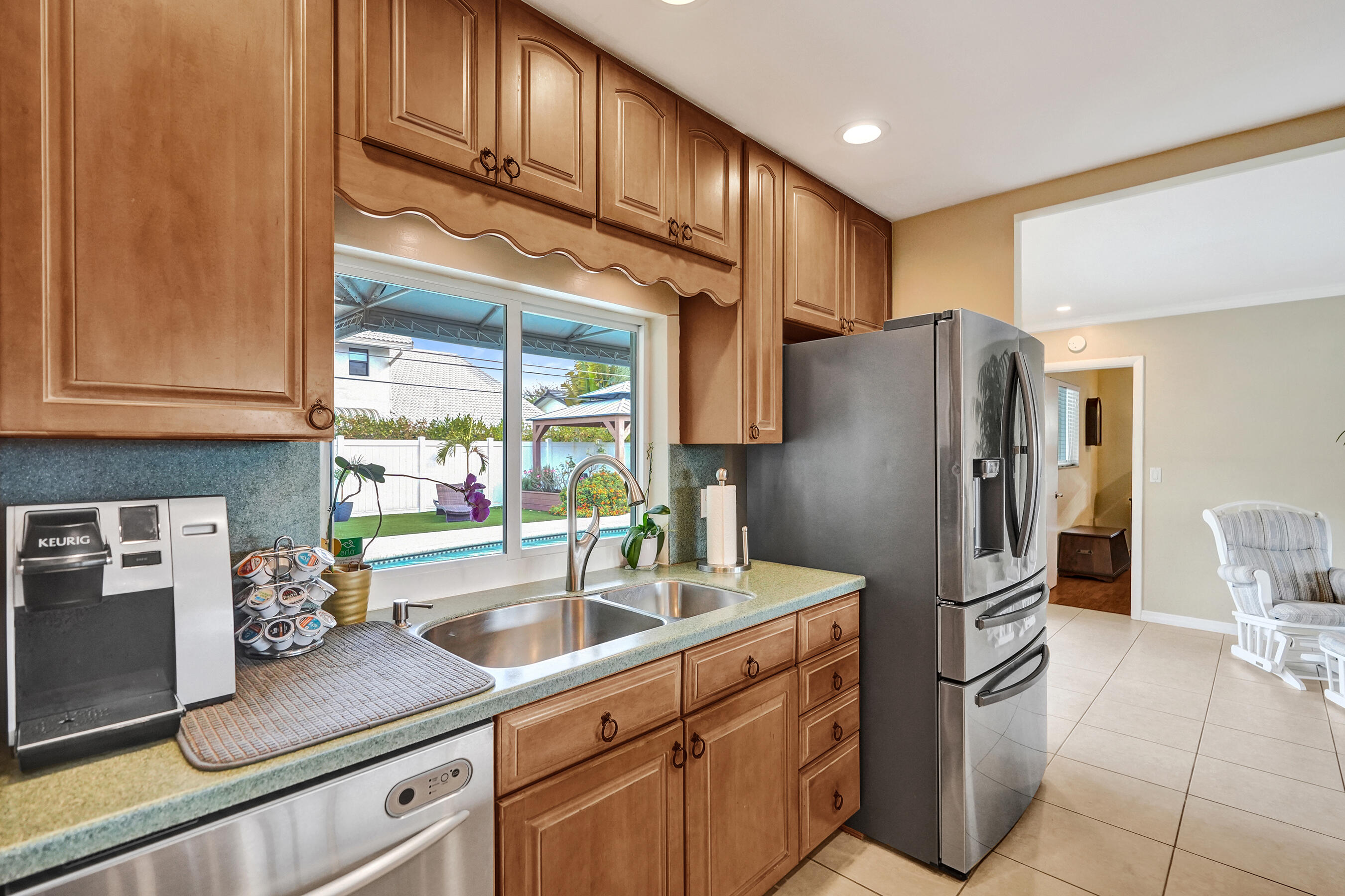 3001 Northeast 45th Street Lighthouse Point, FL 33064 - Photo 17 of 67 a kitchen with stainless steel appliances granite countertop a refrigerator and a sink