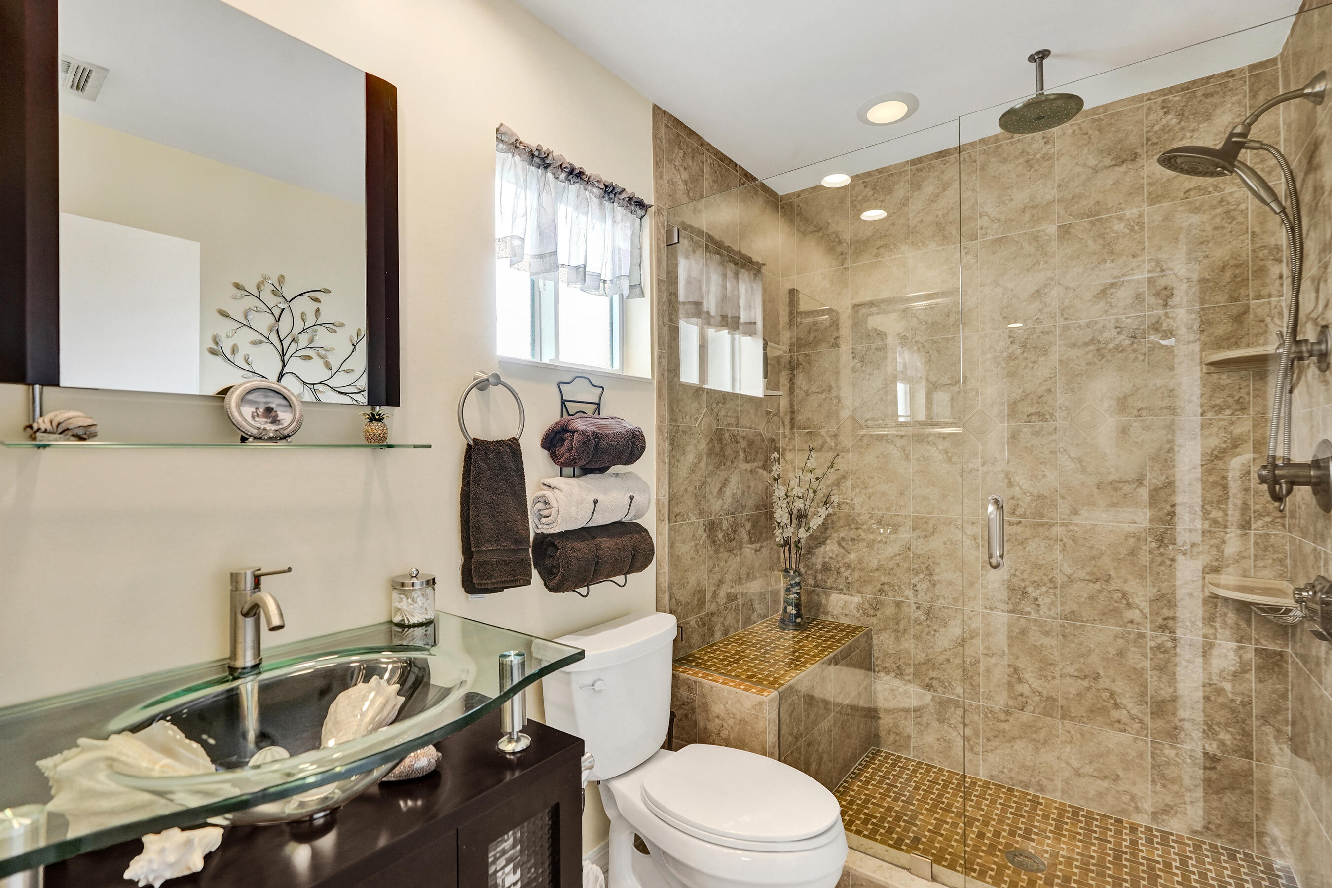 3001 Northeast 45th Street Lighthouse Point, FL 33064 - Photo 24 of 67 a bathroom with a sink toilet a mirror and shower