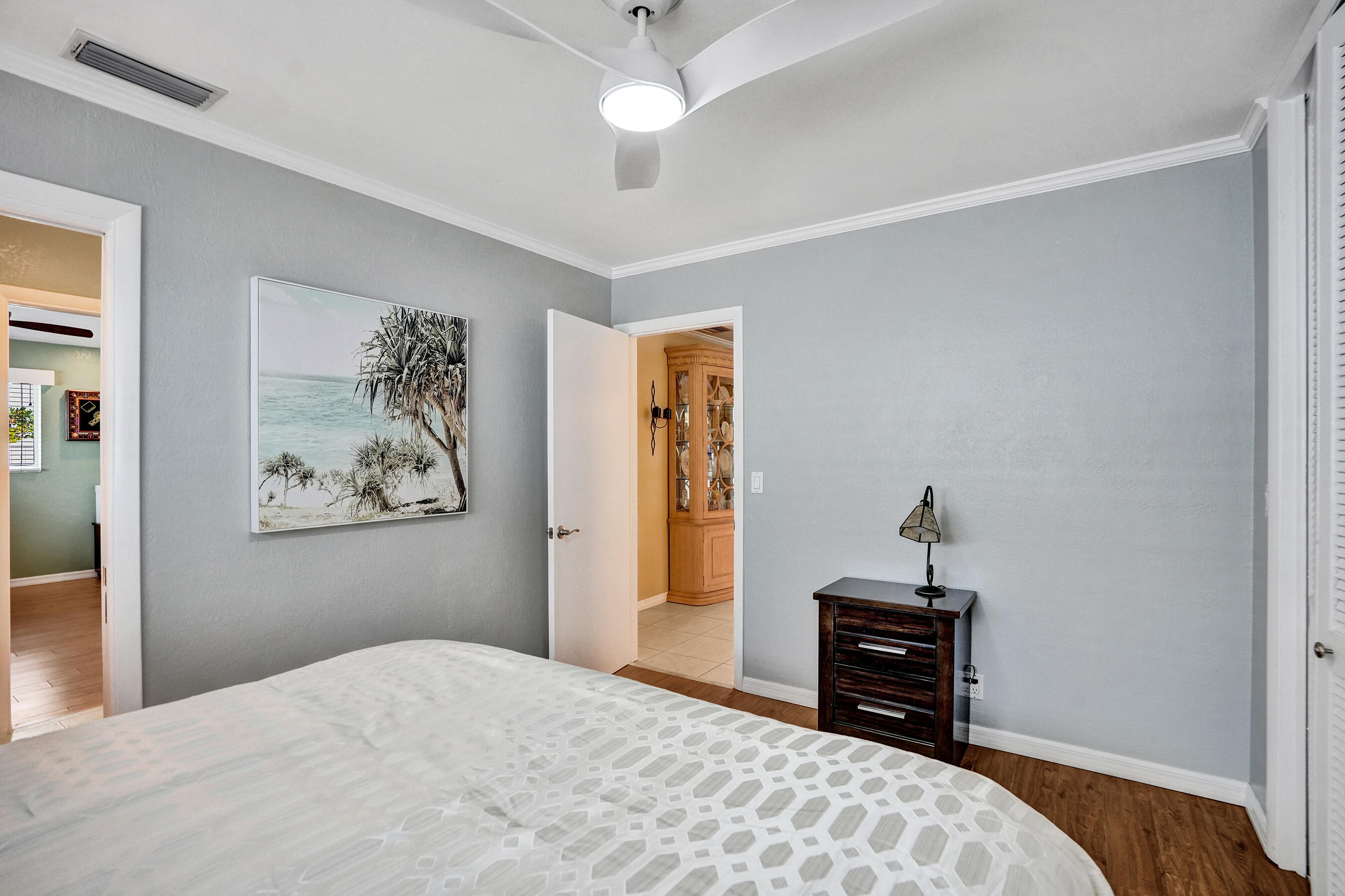 3001 Northeast 45th Street Lighthouse Point, FL 33064 - Photo 30 of 67 a bedroom with a bed and a chandelier