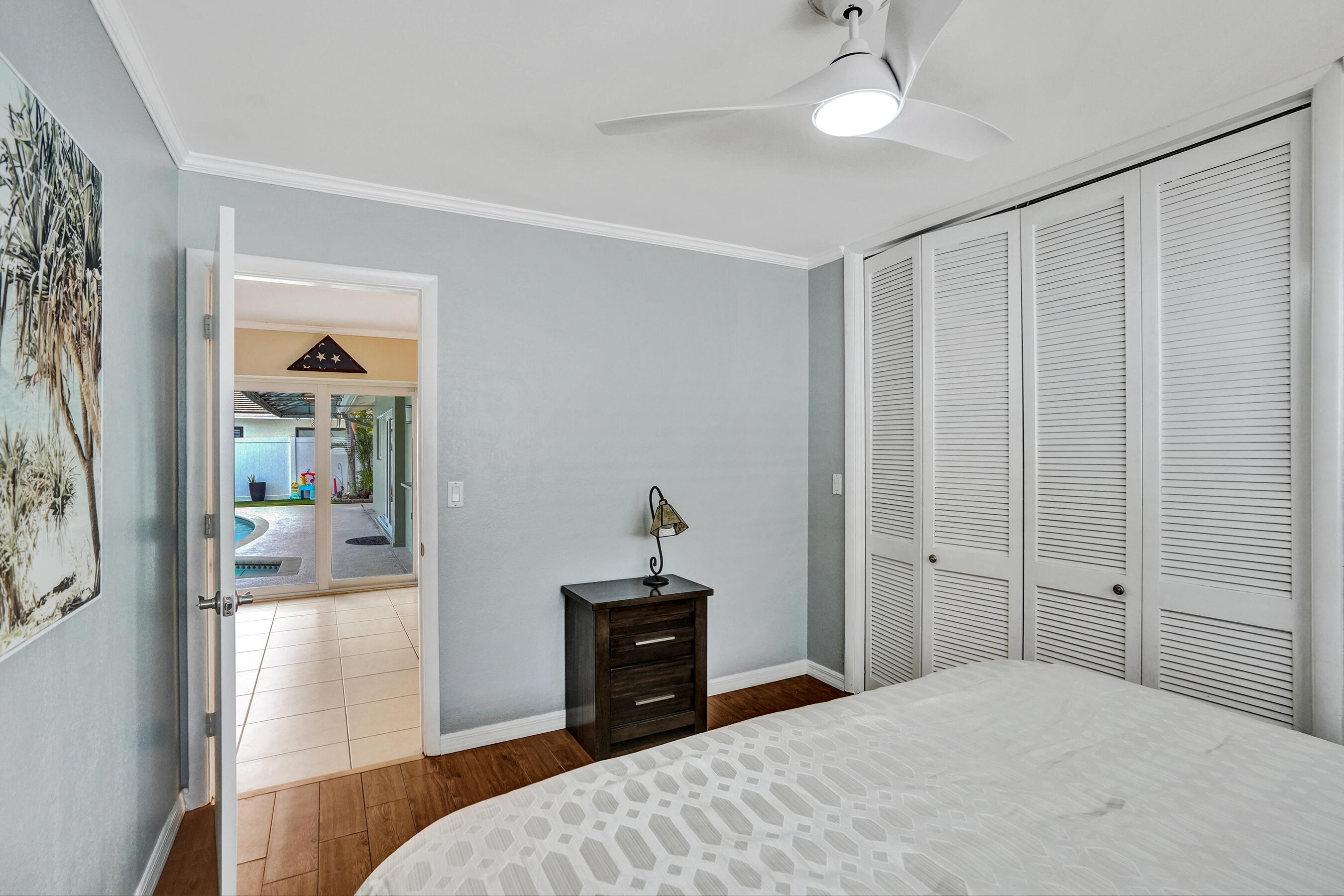 3001 Northeast 45th Street Lighthouse Point, FL 33064 - Photo 32 of 67 a bedroom with a bed and a chandelier